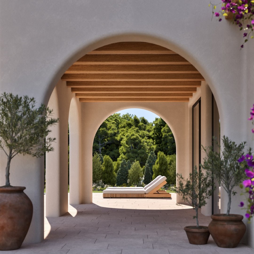 Naya de estilo mediterráneo con arcos clásicos, techos de vigas de madera y suelos de piedra. El espacio exterior incluye macetas de barro y vistas al jardín.