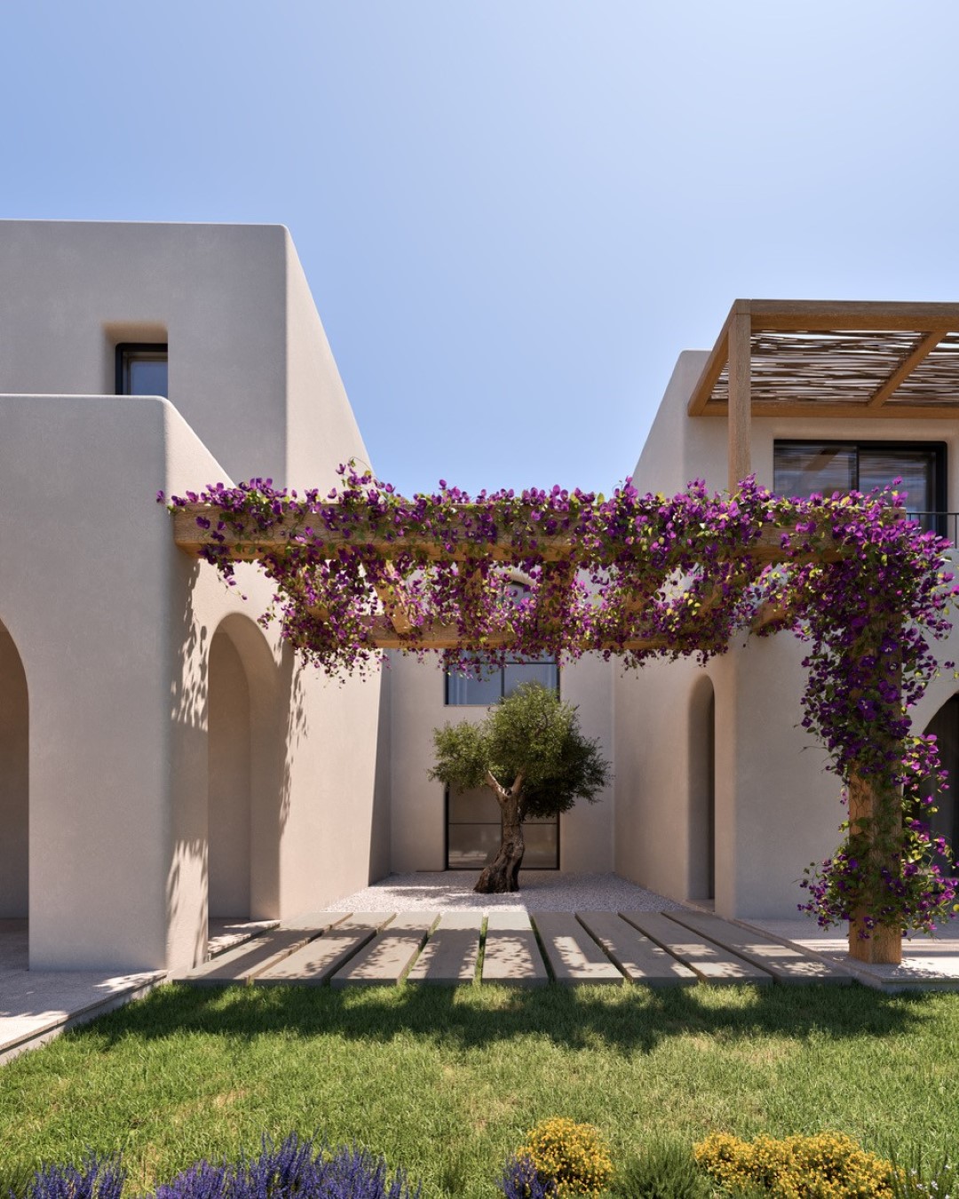 Pérgola de madera con buganvilla sobre un patio central con olivo, arcos mediterráneos y fachada de tonos arena en The White Collection.
