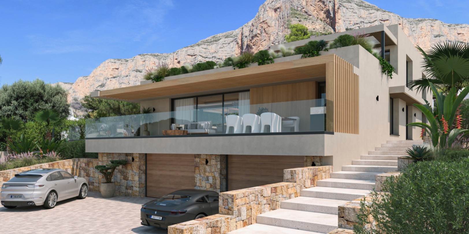 Fachada exterior de diseño moderno con muros de piedra natural, garaje doble y una amplia terraza con barandilla de cristal frente al macizo del Montgó.
