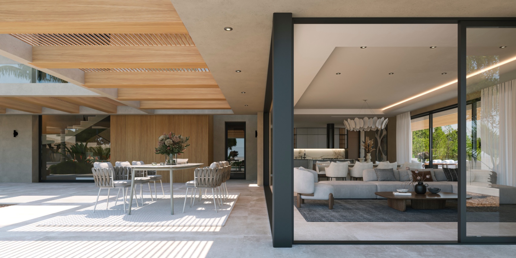 Terraza cubierta con vigas de madera y comedor exterior, integrada al salón diáfano y cocina mediante grandes ventanales de suelo a techo.