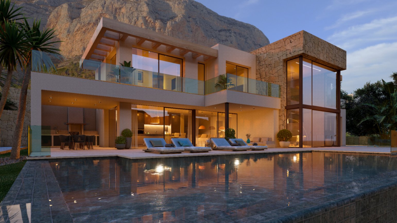 Fachada moderna con muros de piedra natural, amplios ventanales y piscina. La terraza iluminada incluye zona de comedor exterior y vistas al monte Montgó.
