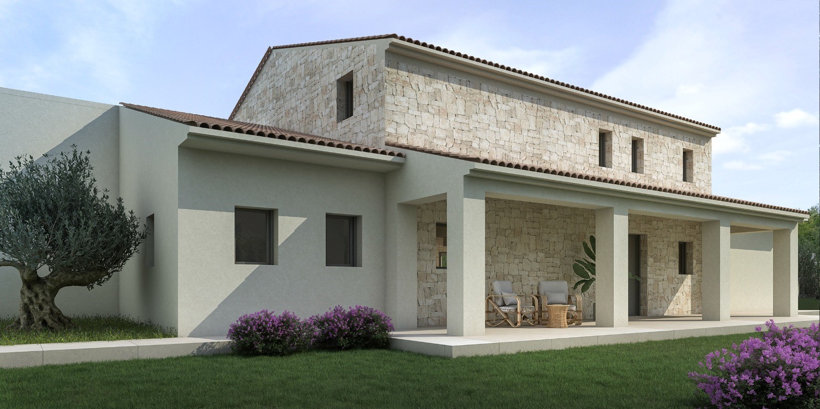 Vista exterior con fachada de piedra natural, tejado de terracota y un porche cubierto con zona de estar, rodeado de césped y vegetación mediterránea.