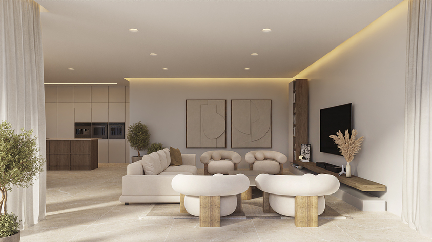 Salón de planta abierta con mobiliario en tonos neutros, sillones curvos y estantería flotante de madera. La iluminación empotrada y el suelo de piedra integran la estancia con la cocina.