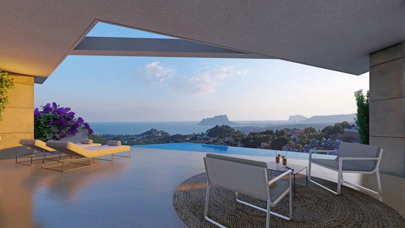 Terraza con piscina infinita y vistas panorámicas al Mediterráneo y al Peñón de Ifach. Incluye mobiliario de diseño y zona de estar cubierta con revestimiento de piedra.
