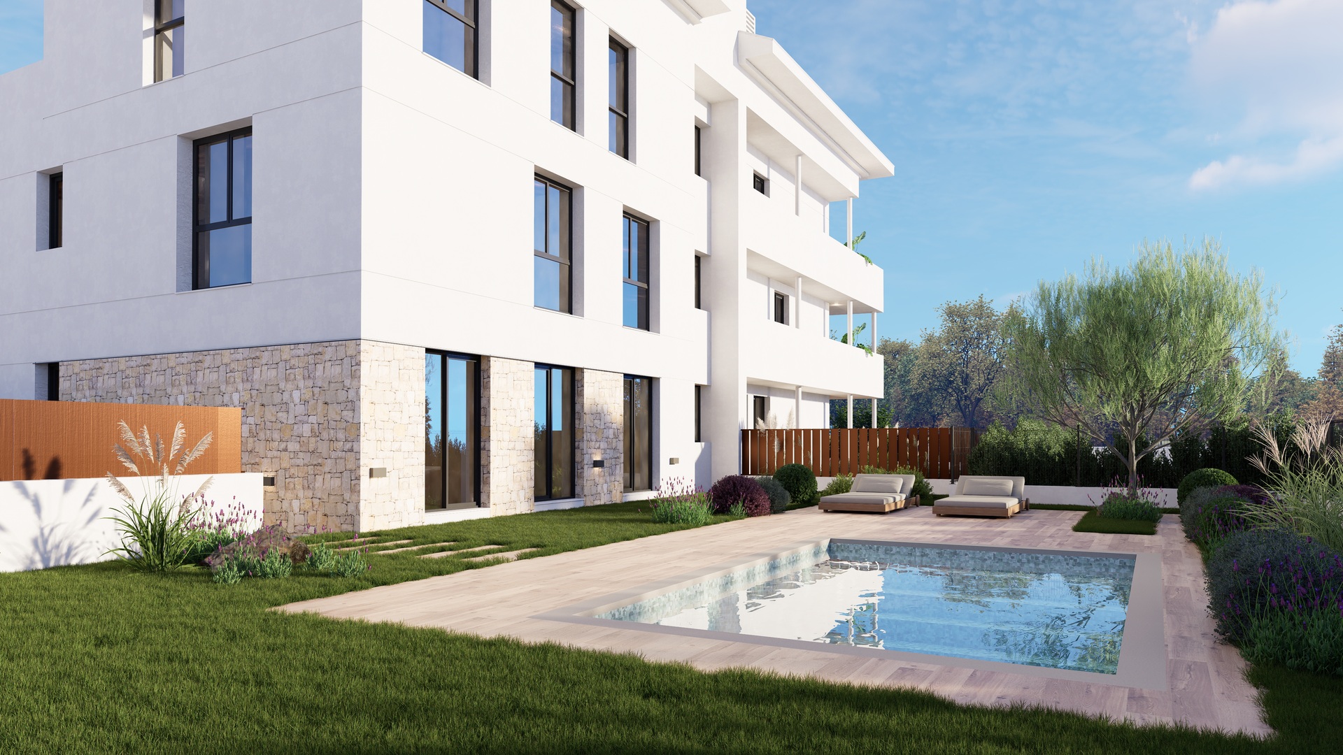 Vista exterior del edificio de tres plantas con fachada blanca y piedra, piscina comunitaria con tarima de madera y zonas verdes con lavanda.
