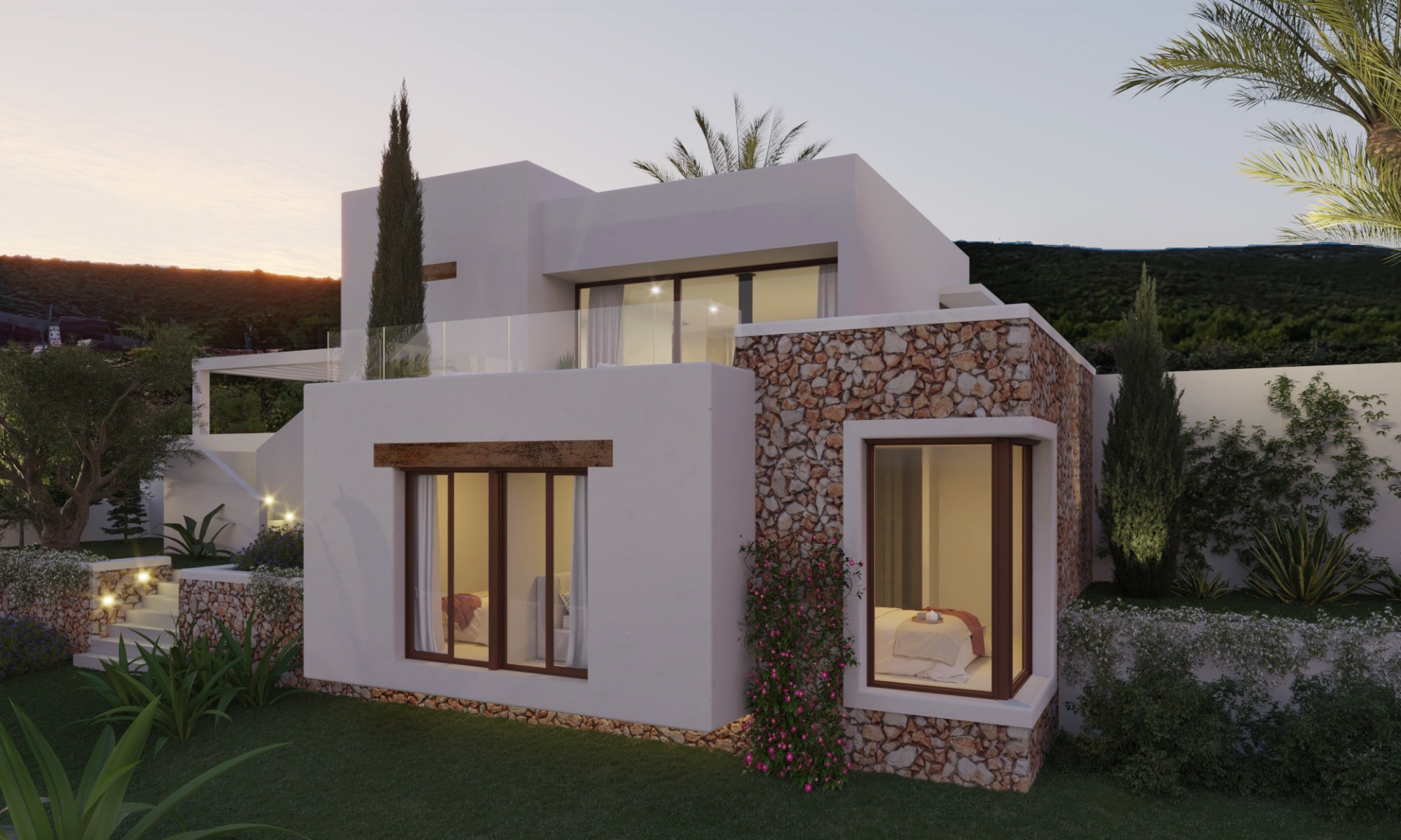 Fachada moderna que combina muros de piedra natural, acabados en blanco y vigas de madera. Los grandes ventanales iluminan los dormitorios inferiores con acceso directo al jardín.