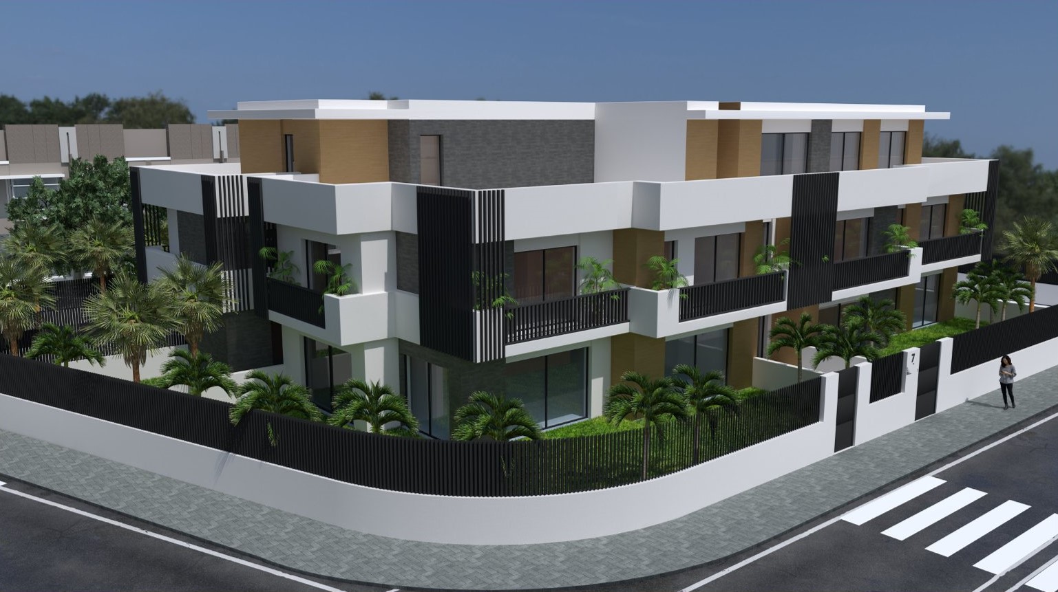 Fachada exterior de un edificio residencial moderno con volúmenes blancos, detalles en madera y piedra gris, rodeado de palmeras y vallado perimetral negro.